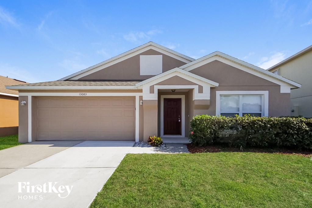 A house with a brown garage door and a white front door.