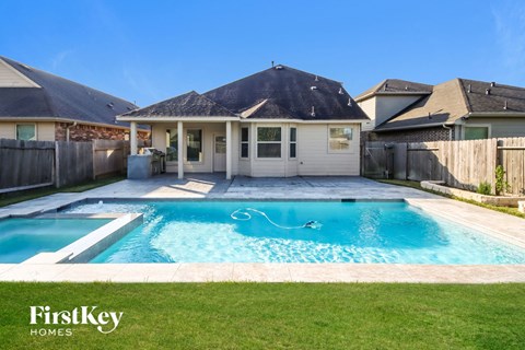 A house with a pool in the backyard.