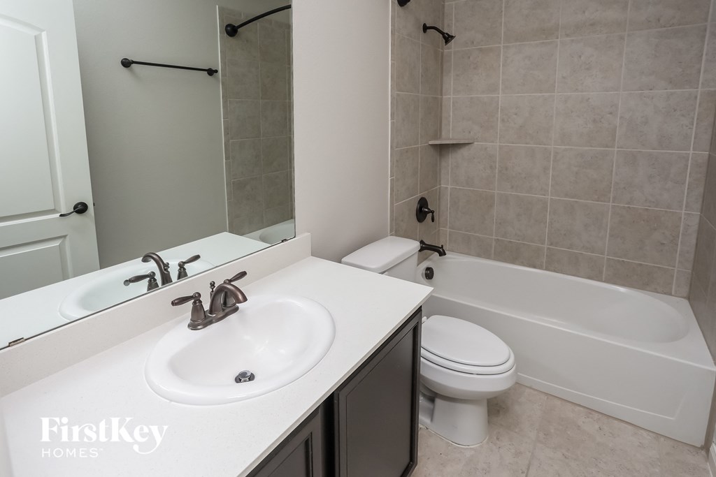 a bathroom with a sink and a tub and a toilet