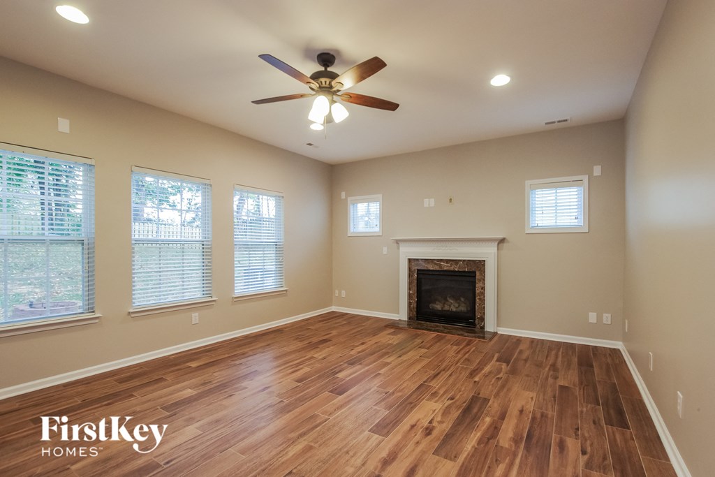 the living room has a fireplace and hardwood floors