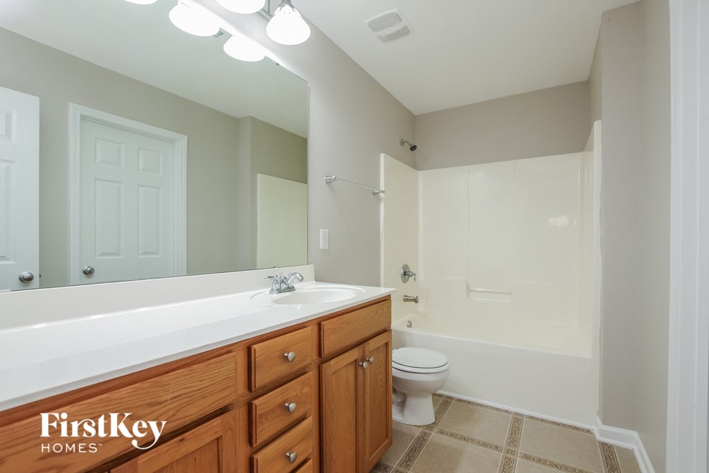 a full view of a bathroom with a sink toilet and shower