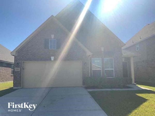 A house with a garage and a driveway is shown in the image.