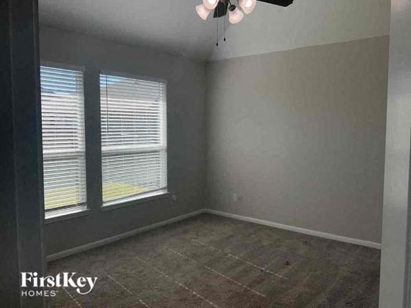 A room with a window and a tiled floor.