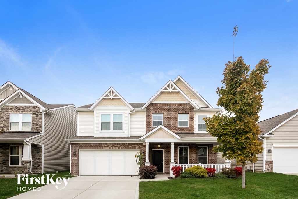 A large house with a garage is shown in the image.