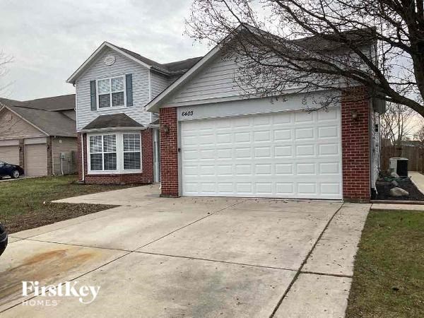 A house with a garage door numbered 6403 is shown.