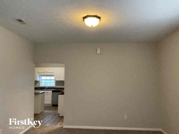 A room with a FirstKey Homes logo on the bottom left corner.