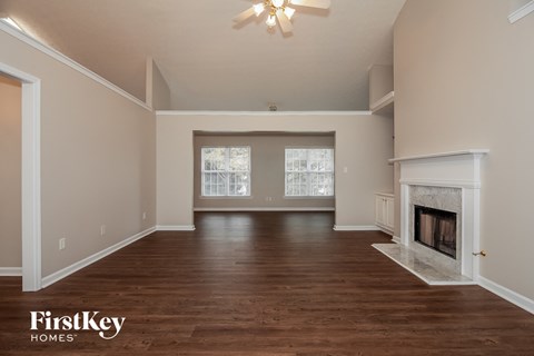 the living room with fireplace and wood flooring