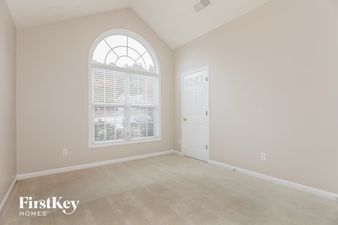 the second bedroom is spacious and clean with a large window