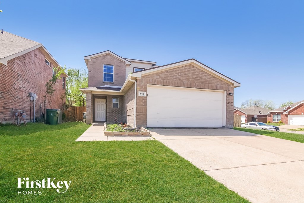 A house with a garage and a driveway is for sale.