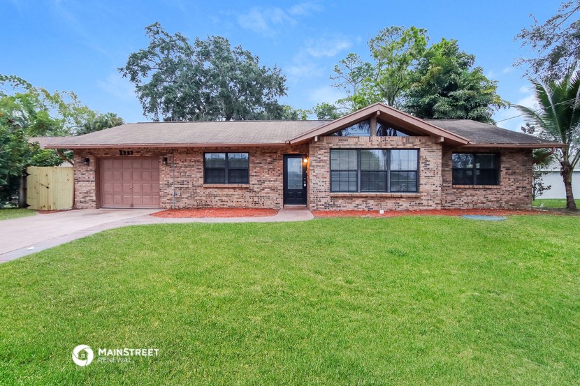 a brick house with a lawn in front of it