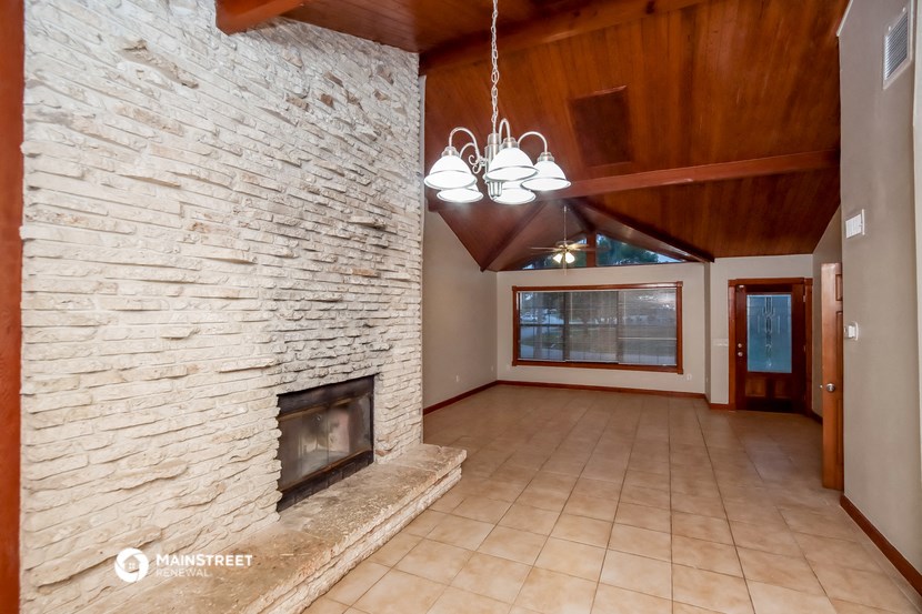 a large stone fireplace in the center of a living room