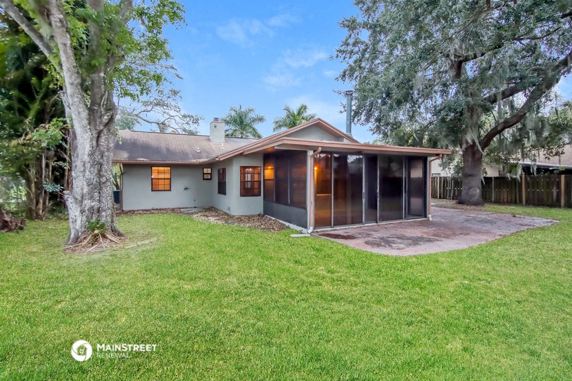 a white house with a yard and a tree