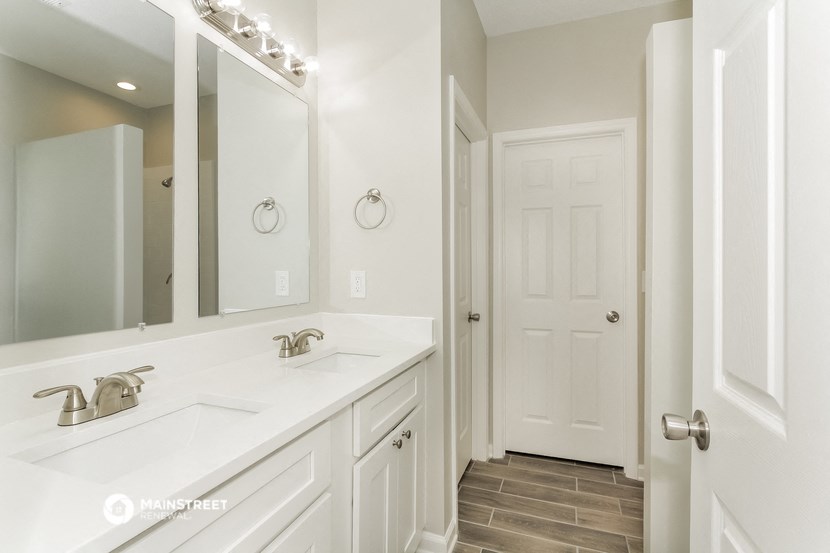 a bathroom with two sinks and a large mirror