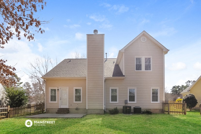 a white house with a chimney on the side of it
