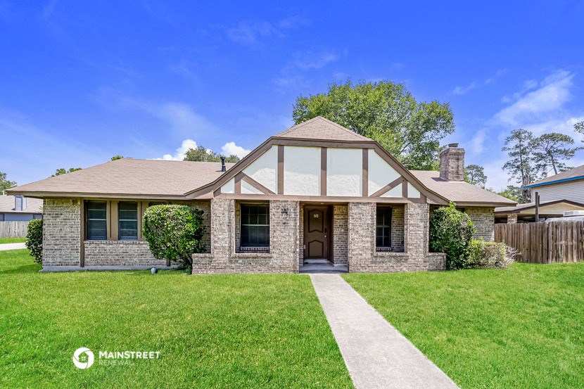 a small brick house with a lawn and a sidewalk