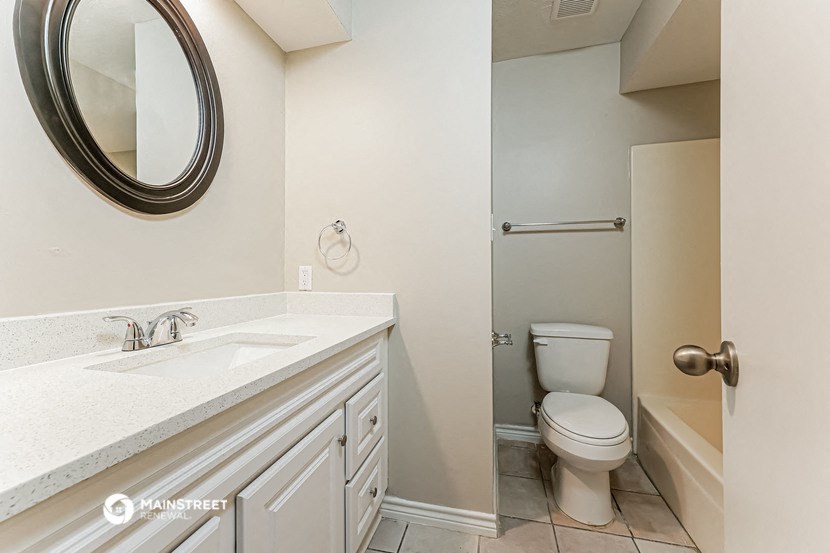 a bathroom with a sink and a toilet and a shower