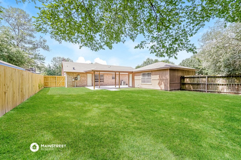 a backyard with a fence and a house
