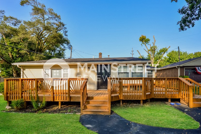 a backyard with a deck and a mobile home