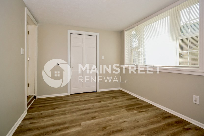 a bedroom with a door and a window