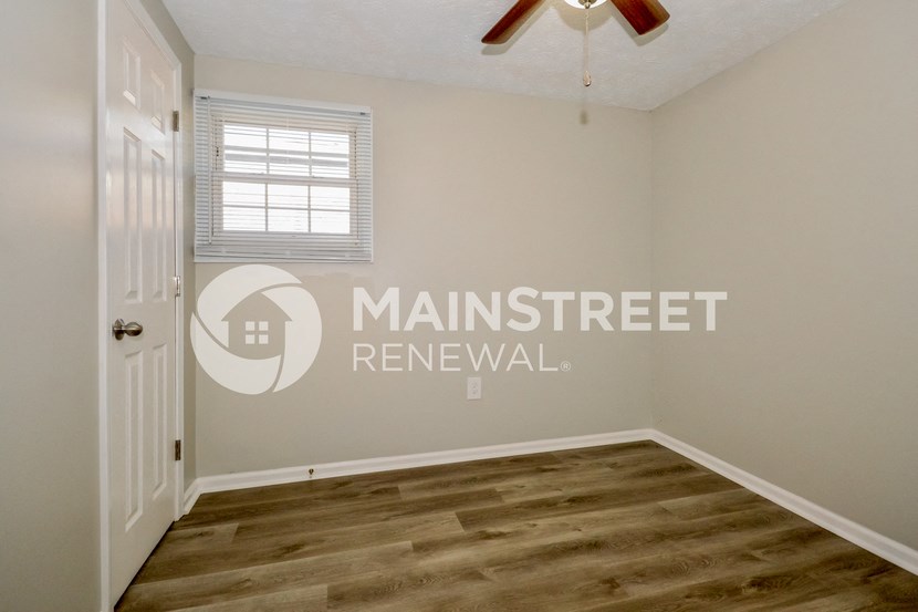 a room with a white door and a window