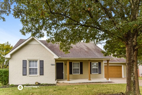 a house with a tree in front of it