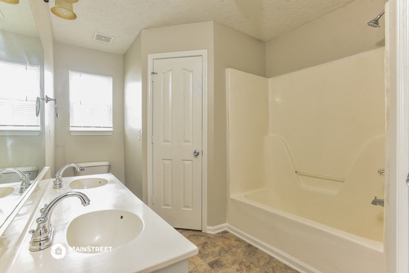 a bathroom with a sink and a tub and a shower
