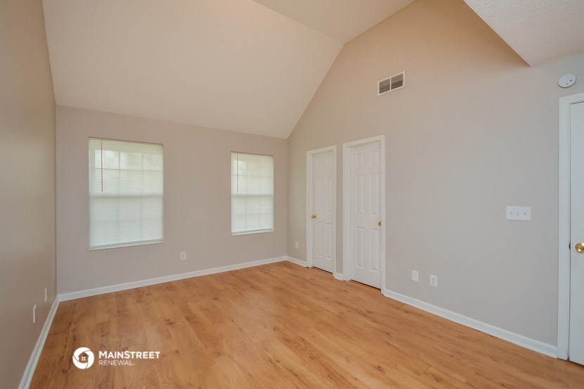 the living room of a house with a wooden floor