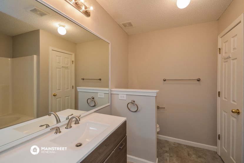 a bathroom with a large mirror and a sink