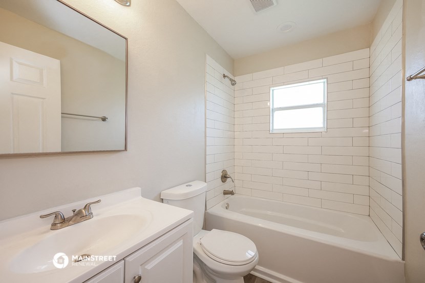 a bathroom with a sink toilet and a bath tub