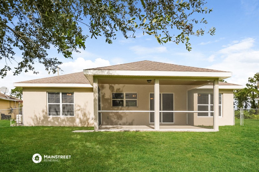 a small house with a lawn and a tree