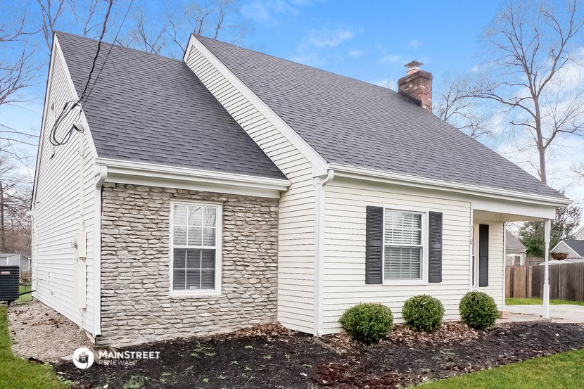 a white house with white siding and a gray roof