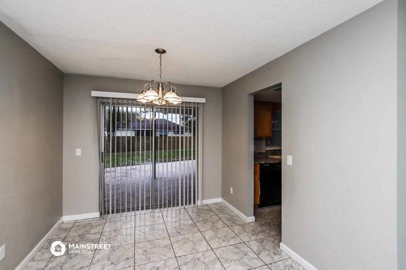 an empty living room with a door to the yard