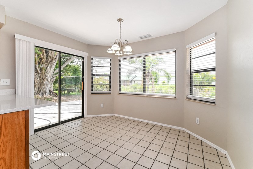 an empty living room with a sliding glass door to a patio