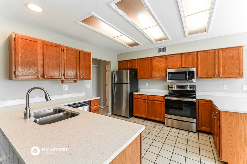 a kitchen with stainless steel appliances and wooden cabinets
