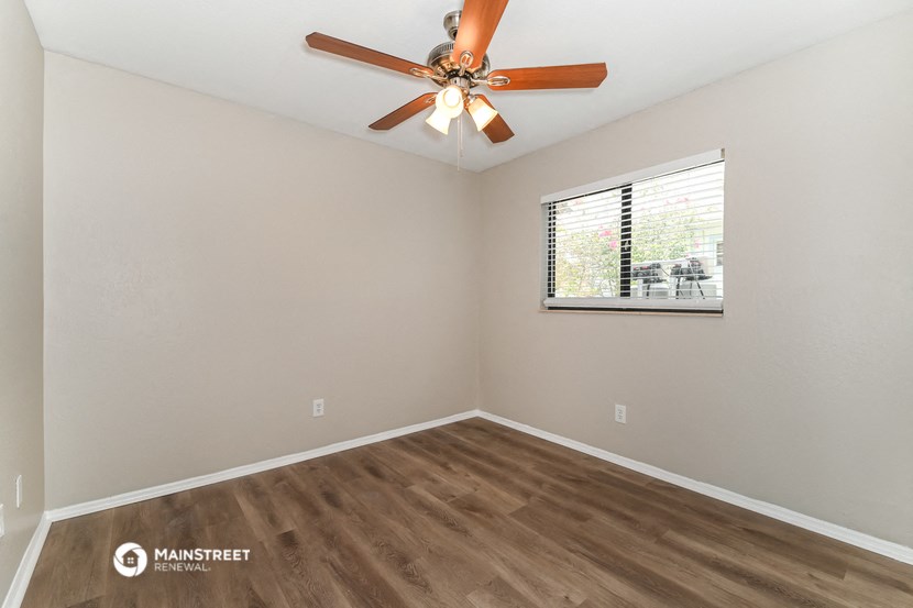 the living room of our studio apartment atrium with ceiling fan and window