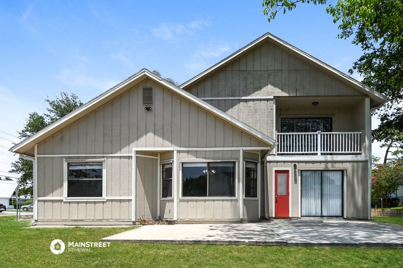 the front of a house with a red door