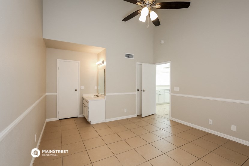 an empty bathroom with a ceiling fan and a sink