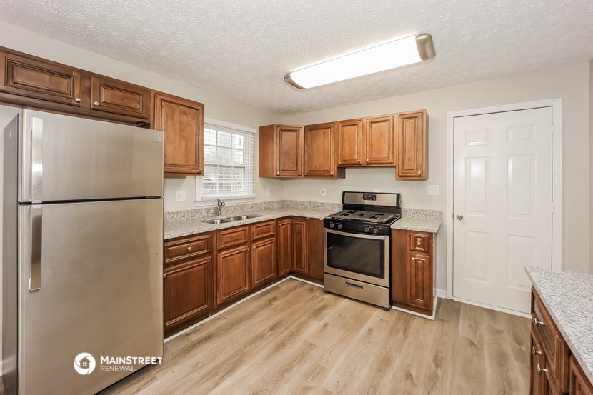 the kitchen of our studio apartment atrium with stainless steel appliances and wooden cabinets