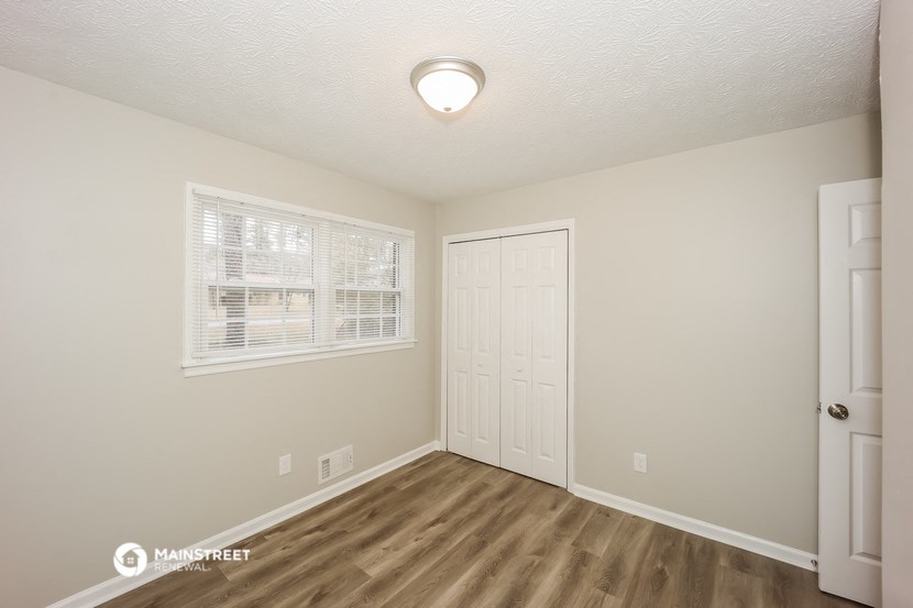 the interior of an empty room with a door and a window