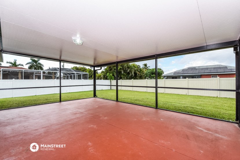 a large glass garage with a grass field outside of it