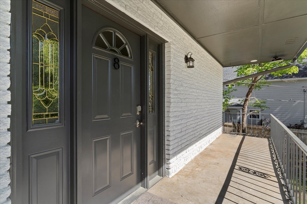 A house with a dark grey front door and a glass window.