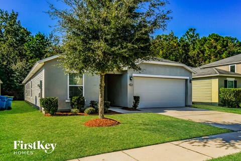 A house with a tree in front of it and the words "FirstKey Homes" on the bottom left.