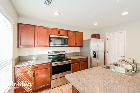 A kitchen with wooden cabinets and stainless steel appliances.