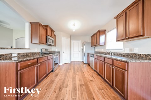 A kitchen with wooden cabinets and a countertop.