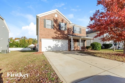 a large brick house with a white garage door in front of it