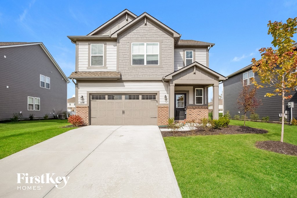 A large house with a driveway in front of it.