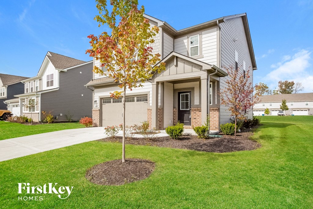 A house with a tree in front of it.