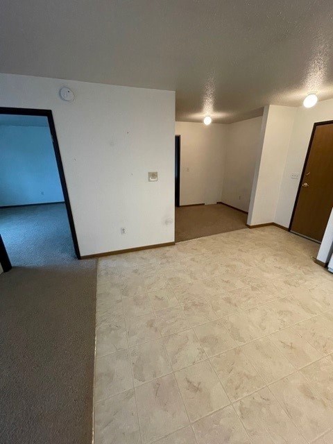 A room with a brown door and a white wall.