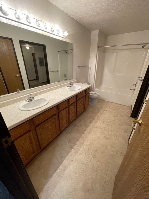 A bathroom with a sink, mirror, and toilet.