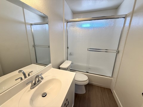 A white sink and toilet in a small bathroom.